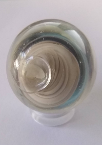 marble that I made that cracked along the punty side. The marble is mostly grey swirl.