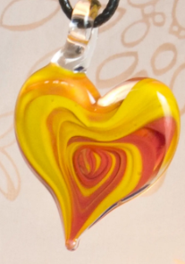 Finished glass heart featuring coral, orange, and yellow swirls
