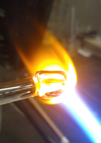 Picture of a glass heart being made. Soft glass with swirl pattern in fire.