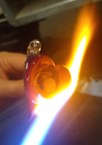 Almost finished heart in fire. Heart has an opal in the middle.